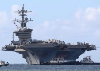 The Nimitz-class aircraft carrier USS Abraham Lincoln arrives at Naval Base Guam for a scheduled port visit on Dec. 11, 2025.