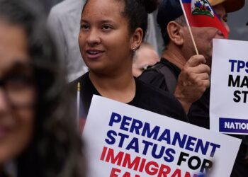 People hold Haitian flags and signs during a July 2026 rally in San Diego in support of immigrants living in the U.S. with Temporary Protected Status. AP Photo/Gregory Bull